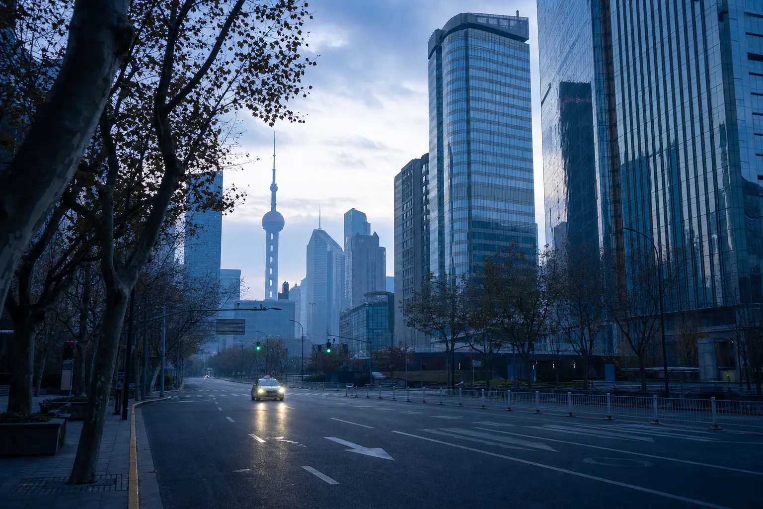 An empty city avenue at dawn with a single taxi approaching between glass towers