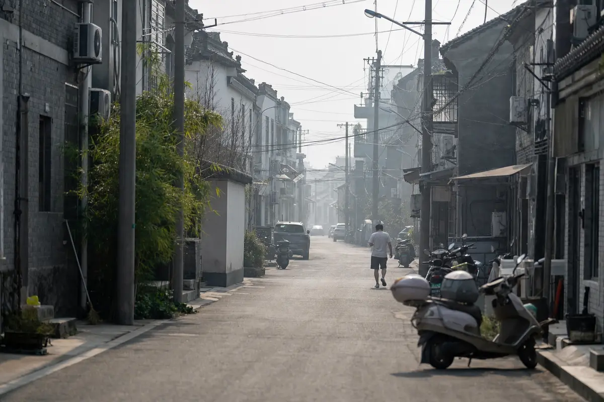 A hazy lowland city street in heavy summer heat with the horizon lost in humidity
