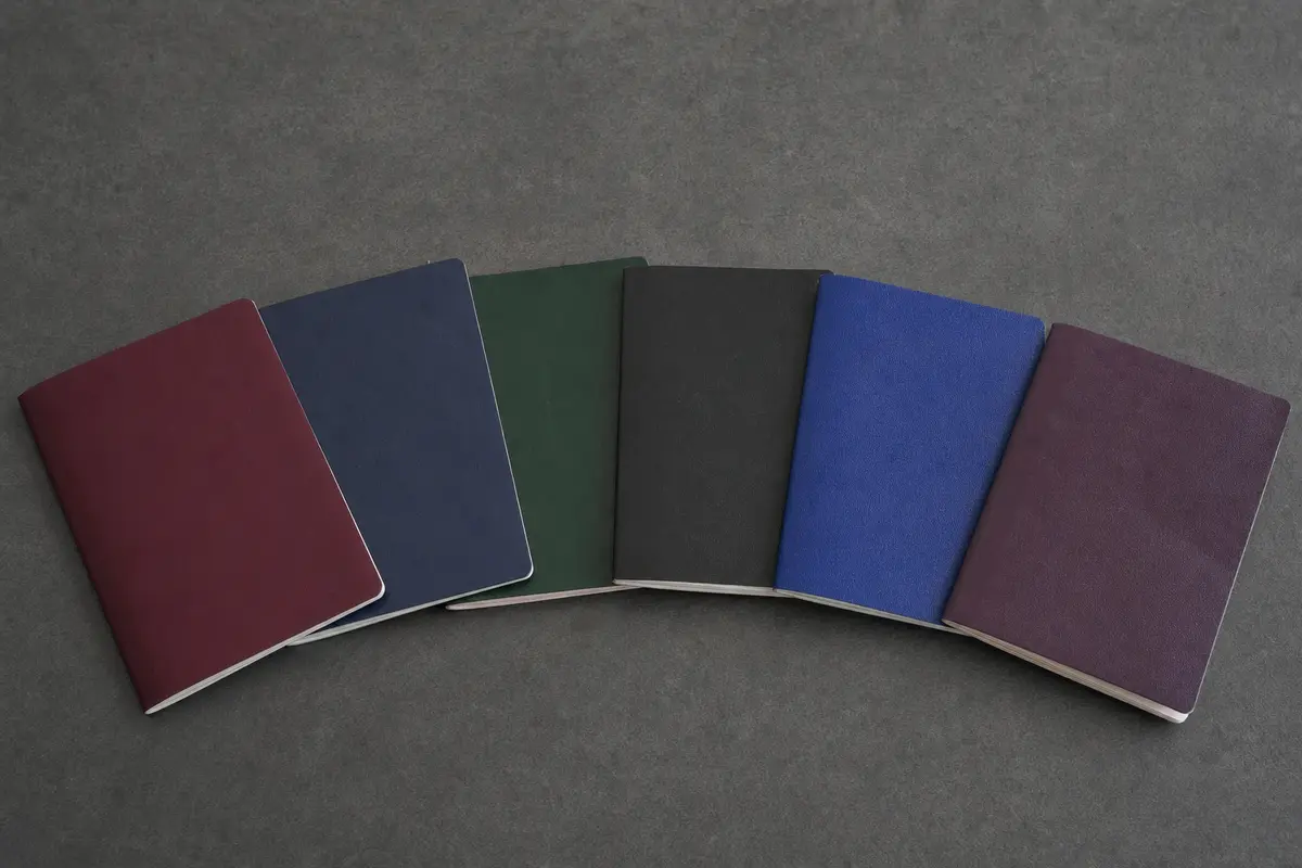 Several passports fanned out on a plain dark table