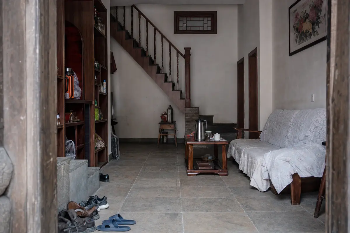 The tiled entrance hall of a family run guesthouse doubling as a sitting room